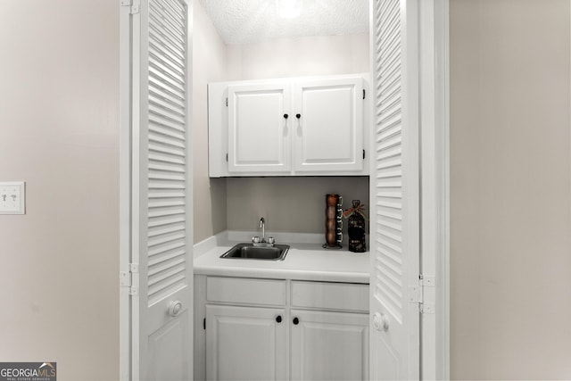 1155 Springway Dr, Gainesville, GA 30501 - bar featuring a sink, wet bar, and a textured ceiling