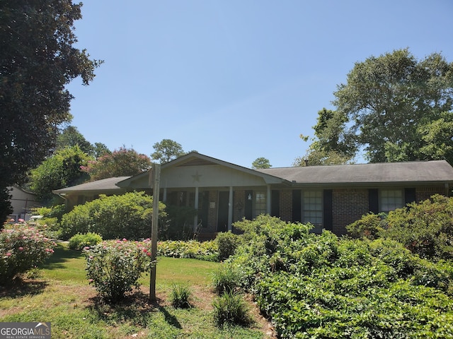 exterior space with a lawn and brick siding