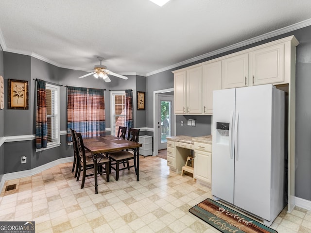 dining room with visible vents, baseboards, crown molding, and ceiling fan