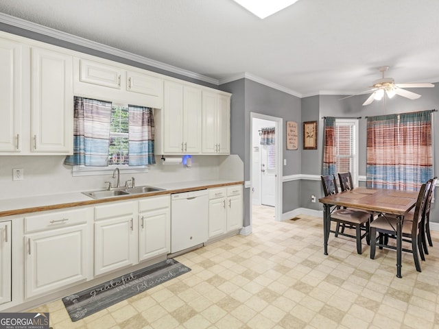 kitchen featuring light floors, ornamental molding, a sink, and dishwasher