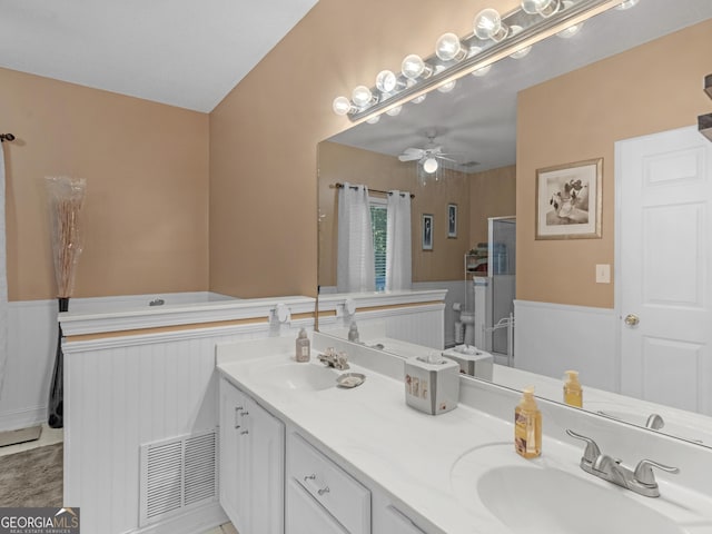 full bathroom featuring a sink, a ceiling fan, double vanity, and visible vents