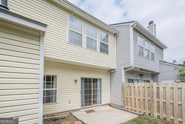 3746 Berkeley Xing, Duluth, GA 30096 - back of property with fence, a chimney, and a patio area