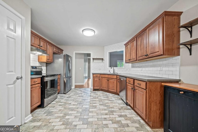kitchen featuring open shelves, a sink, appliances with stainless steel finishes, and under cabinet range hood