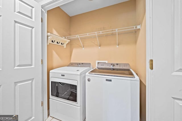 clothes washing area featuring laundry area and washer and dryer