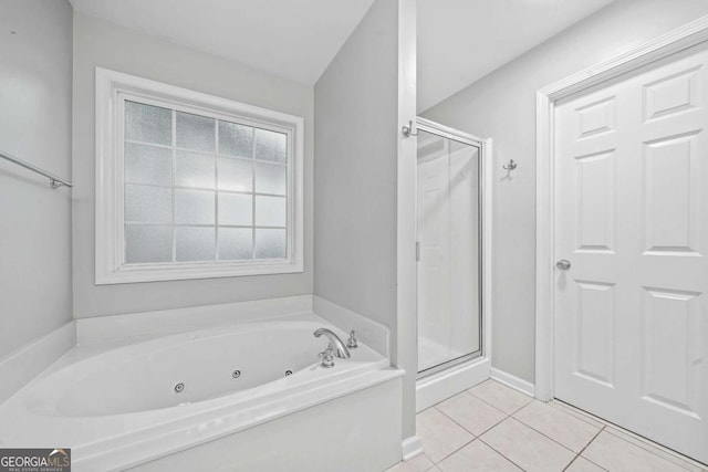 bathroom with baseboards, a jetted tub, tile patterned flooring, and a stall shower