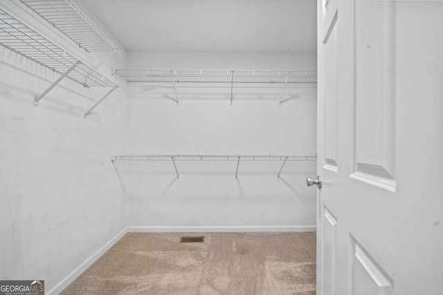 walk in closet featuring carpet floors and visible vents