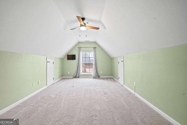 additional living space with carpet flooring, ceiling fan, vaulted ceiling, and baseboards
