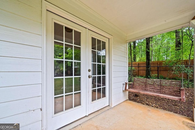exterior space featuring fence and french doors