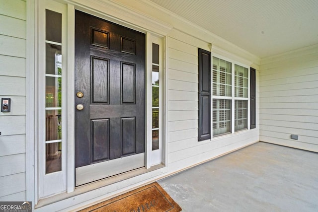 entrance to property featuring covered porch