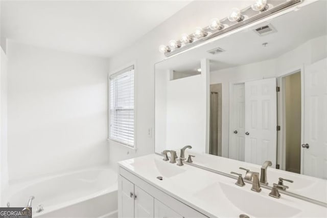 6080 Indian Wood Cir, Mableton, GA 30126 - bathroom featuring a sink, a garden tub, double vanity, and visible vents