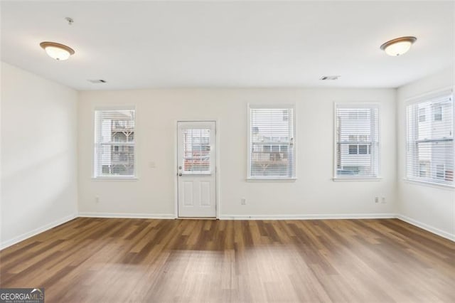6080 Indian Wood Cir, Mableton, GA 30126 - spare room with baseboards, visible vents, and wood finished floors