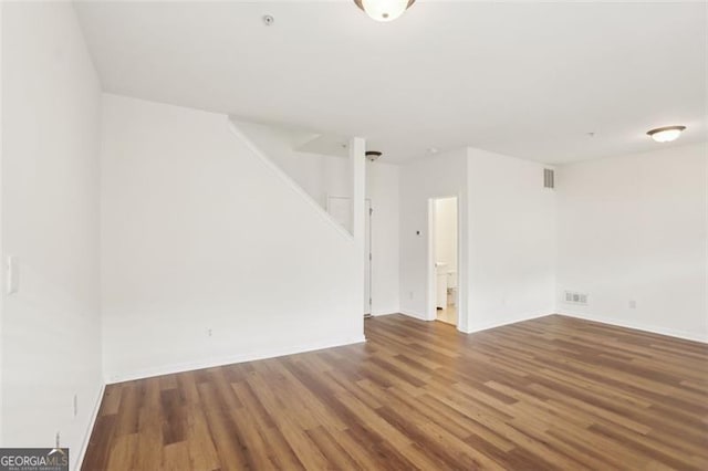 6080 Indian Wood Cir, Mableton, GA 30126 - spare room featuring stairway, baseboards, wood finished floors, and visible vents