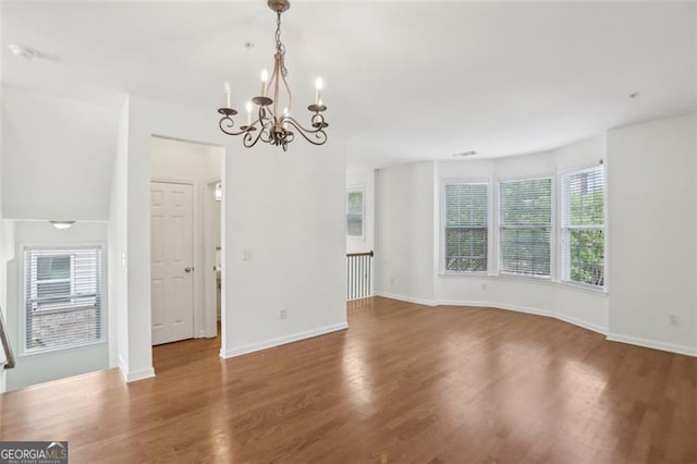 6080 Indian Wood Cir, Mableton, GA 30126 - interior space with baseboards, wood finished floors, and a notable chandelier