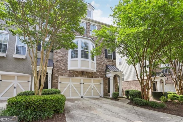 6080 Indian Wood Cir, Mableton, GA 30126 - view of property with an attached garage, stone siding, brick siding, and concrete driveway