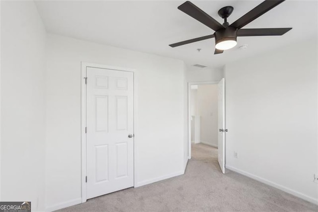 6080 Indian Wood Cir, Mableton, GA 30126 - unfurnished bedroom with baseboards, light carpet, a ceiling fan, and visible vents
