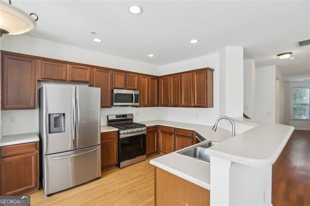 6080 Indian Wood Cir, Mableton, GA 30126 - kitchen featuring light wood finished floors, light countertops, stainless steel appliances, recessed lighting, and a peninsula