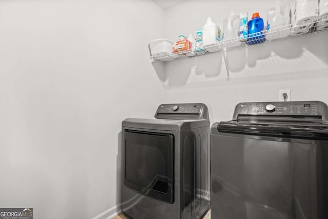 3135 Ellenton Dr, Lithia Springs, GA 30122 - laundry area featuring separate washer and dryer and baseboards