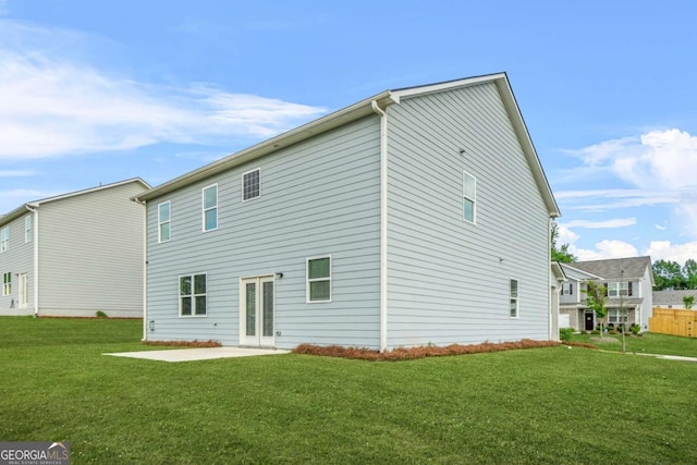 3135 Ellenton Dr, Lithia Springs, GA 30122 - rear view of house with a patio and a lawn