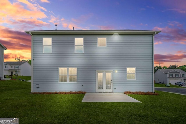 3135 Ellenton Dr, Lithia Springs, GA 30122 - back of house at dusk with a patio area and a lawn