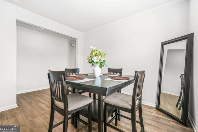 3135 Ellenton Dr, Lithia Springs, GA 30122 - dining area with wood finished floors and ornamental molding