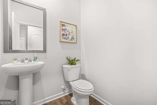 3135 Ellenton Dr, Lithia Springs, GA 30122 - half bathroom featuring baseboards and wood finished floors