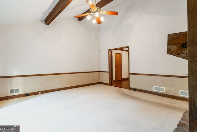 carpeted spare room featuring ceiling fan, beamed ceiling, and visible vents