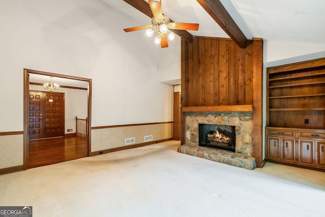 unfurnished living room featuring carpet flooring, beamed ceiling, visible vents, and a fireplace
