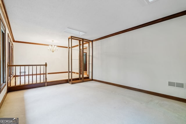 spare room featuring visible vents, ornamental molding, carpet, and baseboards