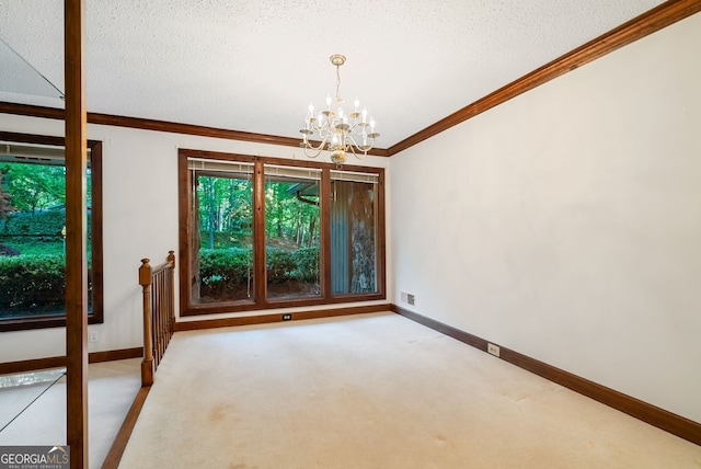 carpeted empty room featuring an inviting chandelier, baseboards, ornamental molding, and visible vents