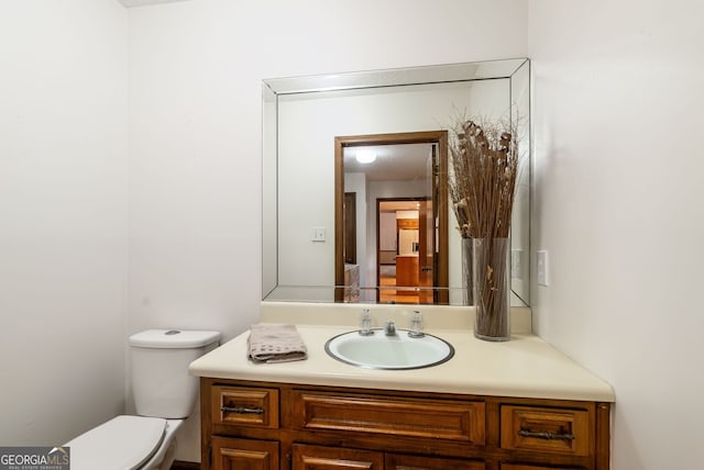 half bath featuring toilet and vanity