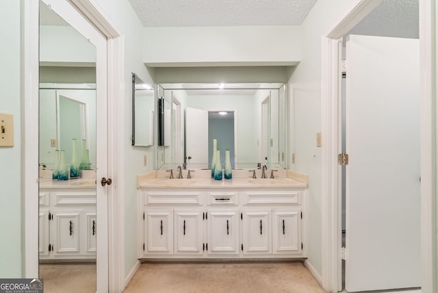 full bathroom featuring double vanity, a sink, and baseboards