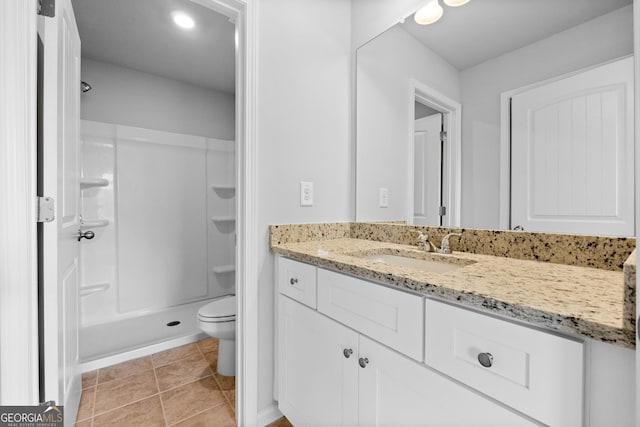 bathroom with vanity, toilet, tile patterned flooring, and a stall shower