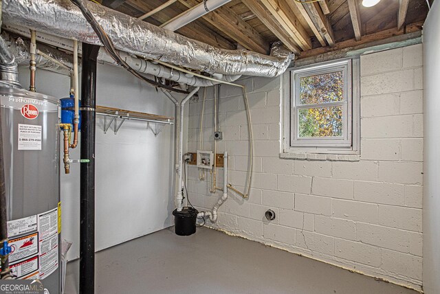 basement with water heater and concrete block wall