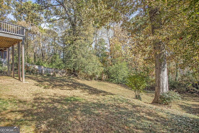 view of yard featuring a deck and fence