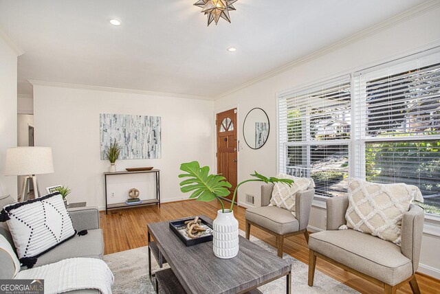 living area with recessed lighting, ornamental molding, baseboards, and wood finished floors