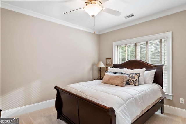bedroom featuring crown molding, ceiling fan, light colored carpet, baseboards, and visible vents