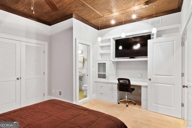 bedroom featuring built in study area, connected bathroom, wood ceiling, and visible vents