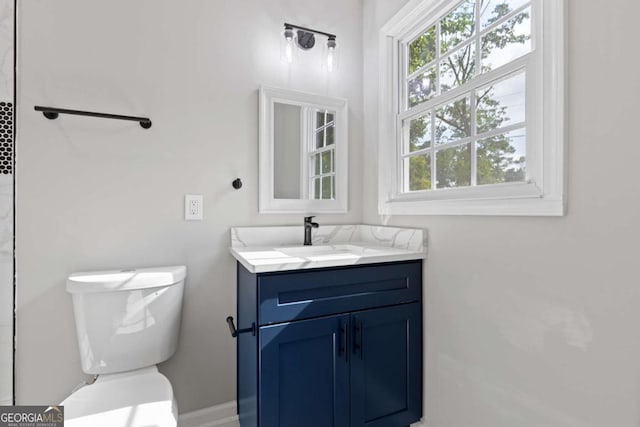 353 Old Rosser Rd, Stone Mountain, GA 30087 - bathroom featuring vanity, baseboards, and toilet