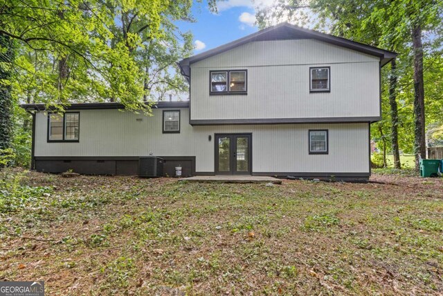 353 Old Rosser Rd, Stone Mountain, GA 30087 - rear view of house with central AC unit, french doors, and crawl space