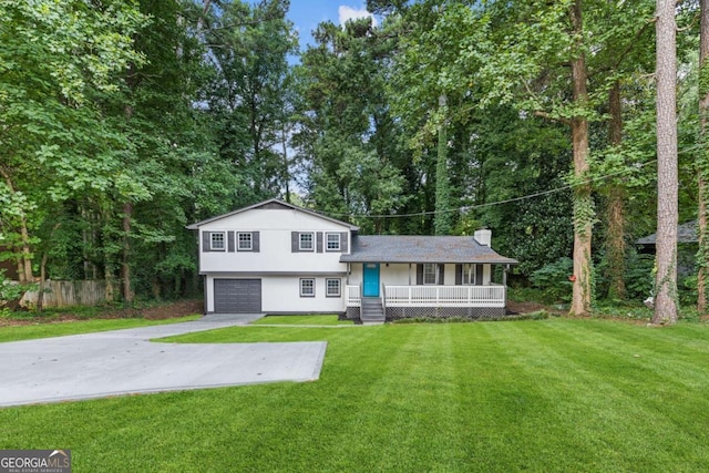 353 Old Rosser Rd, Stone Mountain, GA 30087 - view of front of house with fence, an attached garage, a front yard, covered porch, and driveway