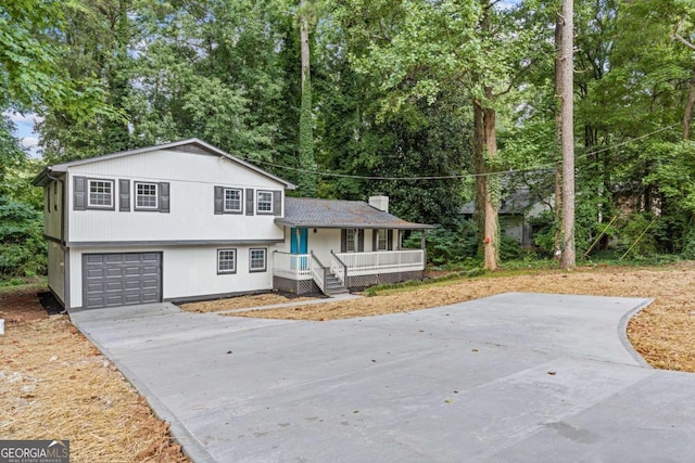 353 Old Rosser Rd, Stone Mountain, GA 30087 - split level home featuring a porch, an attached garage, and driveway