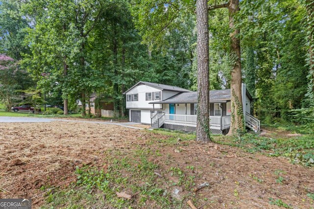 353 Old Rosser Rd, Stone Mountain, GA 30087 - tri-level home featuring an attached garage and a porch