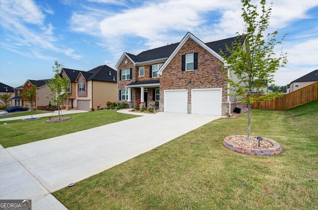 3236 Papyrus Palm Rd, Loganville, GA 30052 - traditional-style home with a garage, fence, a front yard, brick siding, and concrete driveway