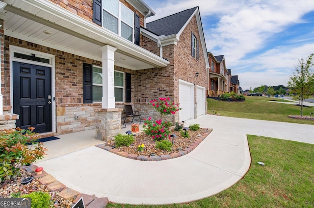 3236 Papyrus Palm Rd, Loganville, GA 30052 - entrance to property with an attached garage, brick siding, concrete driveway, a porch, and a yard