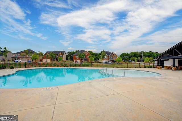 3236 Papyrus Palm Rd, Loganville, GA 30052 - community pool with fence, a patio, and a residential view