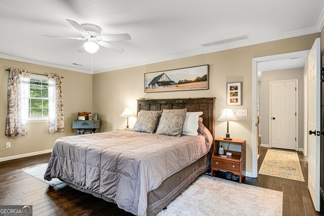 bedroom with visible vents, baseboards, crown molding, and hardwood / wood-style floors