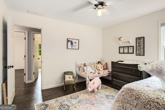 bedroom with baseboards, multiple windows, hardwood / wood-style floors, and visible vents