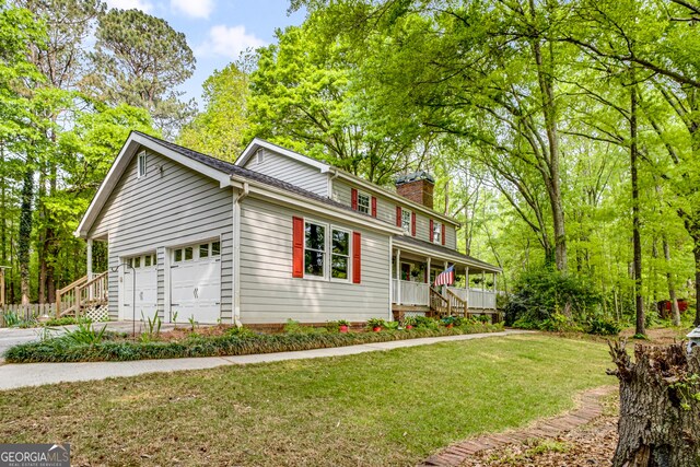 birds eye view of property with a view of trees