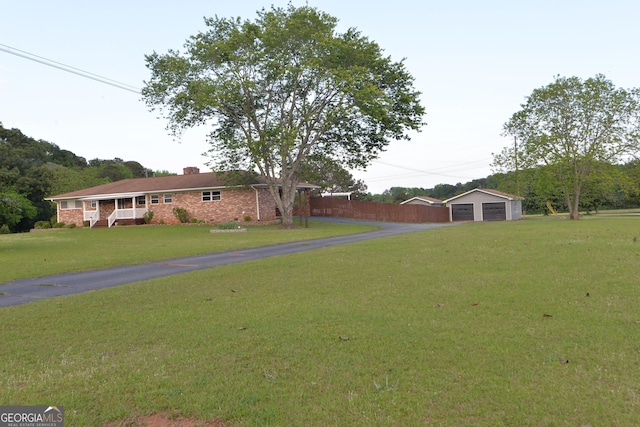 2647 Mount Carmel Rd, Hampton, GA 30228 - view of yard featuring fence, an outdoor structure, and a garage