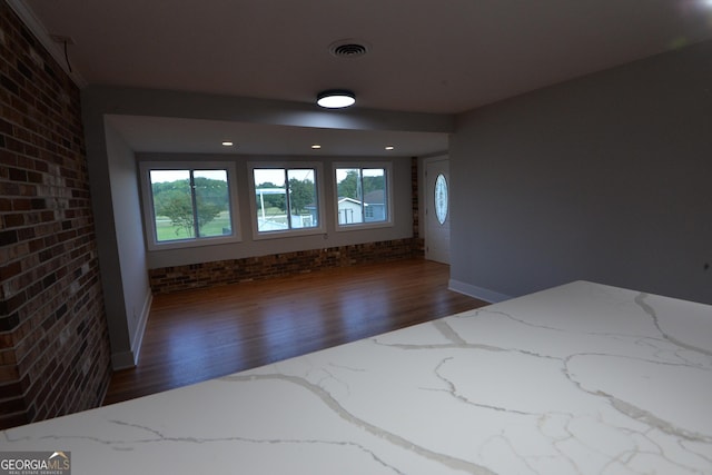 2647 Mount Carmel Rd, Hampton, GA 30228 - interior space with brick wall, baseboards, wood finished floors, and visible vents